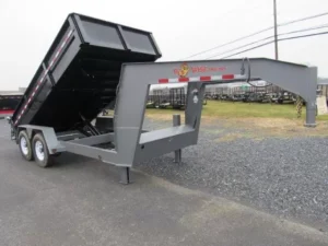 A gray Bwise 7x14 Gooseneck Dump Trailer with a combo gate and ramps, angled to show the rear functionality.