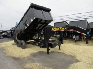 A black Big Tex 7x16 Gooseneck Dump Trailer with solid high sides, parked in an open lot.